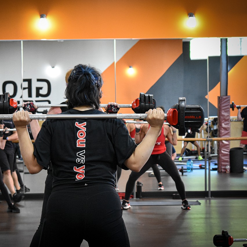 Woman weight lifting in a class.